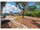 Spacious backyard featuring a tree, a stone walkway, and a decorative fountain, ideal for outdoor enjoyment at 522 Channing Rd, Lakeland, FL 33805