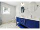 Bathroom vanity with double sinks and striking blue cabinetry, enhanced by sleek fixtures and design at 522 Channing Rd, Lakeland, FL 33805