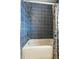 Detailed bathroom with patterned blue tiles and a stylish shower, showcasing modern design at 522 Channing Rd, Lakeland, FL 33805