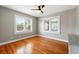 An empty bedroom featuring hardwood floors, a ceiling fan, and lots of natural light at 522 Channing Rd, Lakeland, FL 33805