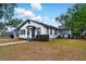 Cozy single-Gathering home featuring a well-maintained lawn and classic white and dark gray trim at 522 Channing Rd, Lakeland, FL 33805