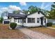 Attractive home with a brick pathway, lush lawn, and contrasting white and dark gray trim at 522 Channing Rd, Lakeland, FL 33805