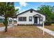 Charming white and dark gray bungalow with well-kept lawn and inviting front entrance at 522 Channing Rd, Lakeland, FL 33805