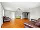 Spacious living room boasting gleaming hardwood floors and an open layout connecting to the dining area at 522 Channing Rd, Lakeland, FL 33805
