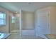 Bright bathroom featuring a walk-in shower, tub, and a window for natural light at 5220 Tennessee Ridge Ct, Auburndale, FL 33823