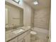 Bathroom features a vanity with granite countertop, white cabinets, and a shower-over-tub at 5220 Tennessee Ridge Ct, Auburndale, FL 33823
