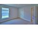 Neutral bedroom with plush carpet, closet doors, and a bright window at 5220 Tennessee Ridge Ct, Auburndale, FL 33823