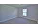 Simple bedroom with plush carpet, a window, and baseboard trim at 5220 Tennessee Ridge Ct, Auburndale, FL 33823