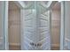 View of a closet featuring symmetrical bi-fold doors and closet shelving at 5220 Tennessee Ridge Ct, Auburndale, FL 33823