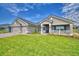 Attractive single-Gathering home with a well-kept lawn, blue shutters, a porch and a three-car garage at 5220 Tennessee Ridge Ct, Auburndale, FL 33823