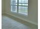 Bright room with tile floor and base molding with a large window that lets in natural light at 5220 Tennessee Ridge Ct, Auburndale, FL 33823