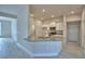 Modern kitchen featuring white cabinets, granite countertops, stainless steel appliances, and a breakfast bar at 5220 Tennessee Ridge Ct, Auburndale, FL 33823