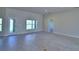 Open-concept living room with tile floors and a glass door leading to the outdoor area at 5220 Tennessee Ridge Ct, Auburndale, FL 33823