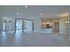 Spacious living area with tile flooring, open to the kitchen and entryway, offering a modern and inviting atmosphere at 5220 Tennessee Ridge Ct, Auburndale, FL 33823