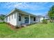 Beautiful backyard with a covered patio, well-maintained lawn, and lush landscaping at 5390 Clubhouse Hills Ln, Lakeland, FL 33812