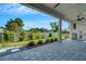 Outdoor living space featuring a covered patio, tile floors, and a well-manicured lawn at 5390 Clubhouse Hills Ln, Lakeland, FL 33812