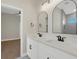 Modern bathroom with double sink vanity, quartz countertop and arched mirrors at 5390 Clubhouse Hills Ln, Lakeland, FL 33812