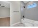 Full bathroom with a shower and tub, gray tile and matte black fixtures at 5390 Clubhouse Hills Ln, Lakeland, FL 33812