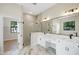 Bright bathroom with double vanity, large mirror and marble flooring creates a luxurious feel at 5390 Clubhouse Hills Ln, Lakeland, FL 33812