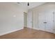 An empty bedroom with hardwood floors, an open doorway, and closet with double doors at 5390 Clubhouse Hills Ln, Lakeland, FL 33812