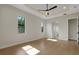 Bright bedroom features wood-look floors, tray ceilings, recessed lights, and a ceiling fan at 5390 Clubhouse Hills Ln, Lakeland, FL 33812