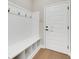 Mud room area with a bench, storage cubbies, coat hooks, and an exterior door at 5390 Clubhouse Hills Ln, Lakeland, FL 33812