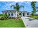 Beautifully landscaped one-story home with a well-manicured lawn and a brick driveway, inviting and full of curb appeal at 5390 Clubhouse Hills Ln, Lakeland, FL 33812