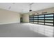 Large, clean garage featuring an epoxy floor, a utility sink, and an automatic door at 5390 Clubhouse Hills Ln, Lakeland, FL 33812