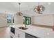 Open kitchen and living area featuring a kitchen island with stainless steel appliances at 5390 Clubhouse Hills Ln, Lakeland, FL 33812