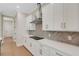 Modern kitchen with white cabinets, quartz countertops, and stainless steel hood at 5390 Clubhouse Hills Ln, Lakeland, FL 33812