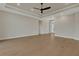 Bright living room with tray ceiling, ceiling fan, recessed lights, and wood-look flooring at 5390 Clubhouse Hills Ln, Lakeland, FL 33812