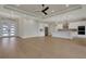 Open living space with white kitchen, hardwood floors and lots of natural light from entry door at 5390 Clubhouse Hills Ln, Lakeland, FL 33812