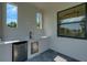 Outdoor kitchen featuring a sink, mini fridge, and modern windows to let in natural light at 5390 Clubhouse Hills Ln, Lakeland, FL 33812
