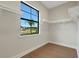 Walk-in closet with open shelving and a large window bringing in natural light at 5390 Clubhouse Hills Ln, Lakeland, FL 33812