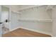 Spacious walk-in closet with ample shelving and easy access to the Primary bathroom at 5390 Clubhouse Hills Ln, Lakeland, FL 33812