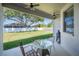 Covered back patio with ceiling fans and outdoor seating overlooking the spacious backyard and lawn at 5531 Pebble Beach Dr, Lakeland, FL 33812