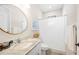 Bathroom with granite countertops, round mirror, and shower with curtain at 5531 Pebble Beach Dr, Lakeland, FL 33812
