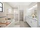 Luxurious bathroom with a soaking tub, walk-in shower, double vanity, and modern finishes at 5531 Pebble Beach Dr, Lakeland, FL 33812