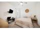Well-lit bedroom with ceiling fan, a wall mounted TV, and large window at 5531 Pebble Beach Dr, Lakeland, FL 33812