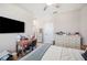 Bedroom with a large wall-mounted TV, desk, chair and dresser at 5531 Pebble Beach Dr, Lakeland, FL 33812