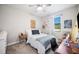 Bright bedroom with ceiling fan and modern desk and chair by the window at 5531 Pebble Beach Dr, Lakeland, FL 33812