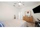 Bedroom with ceiling fan and television, and large dresser with mirror at 5531 Pebble Beach Dr, Lakeland, FL 33812