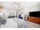 Bright bedroom featuring carpet, neutral tones, ceiling fan, and charming decor at 5531 Pebble Beach Dr, Lakeland, FL 33812