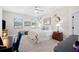 Spacious bedroom with neutral tones, ceiling fan, large windows, and charming decor at 5531 Pebble Beach Dr, Lakeland, FL 33812