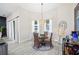 Well-lit dining area with a glass top table, modern light fixture, and inviting decor for gatherings at 5531 Pebble Beach Dr, Lakeland, FL 33812