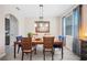 Inviting dining room with a wooden table, elegant chandelier, and natural light streaming in from a window at 5531 Pebble Beach Dr, Lakeland, FL 33812