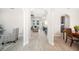 Open-concept foyer with wood-look tile flooring leading to the living room and kitchen at 5531 Pebble Beach Dr, Lakeland, FL 33812