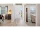 Bright foyer with wood-look tile flooring, arched doorways, and a view to the front door at 5531 Pebble Beach Dr, Lakeland, FL 33812