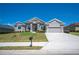 Well-maintained home with a manicured lawn and landscaped garden beds at 5531 Pebble Beach Dr, Lakeland, FL 33812