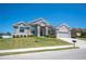 Charming single-story home with well-maintained landscaping, gray stucco, stone accents and a two-car garage at 5531 Pebble Beach Dr, Lakeland, FL 33812